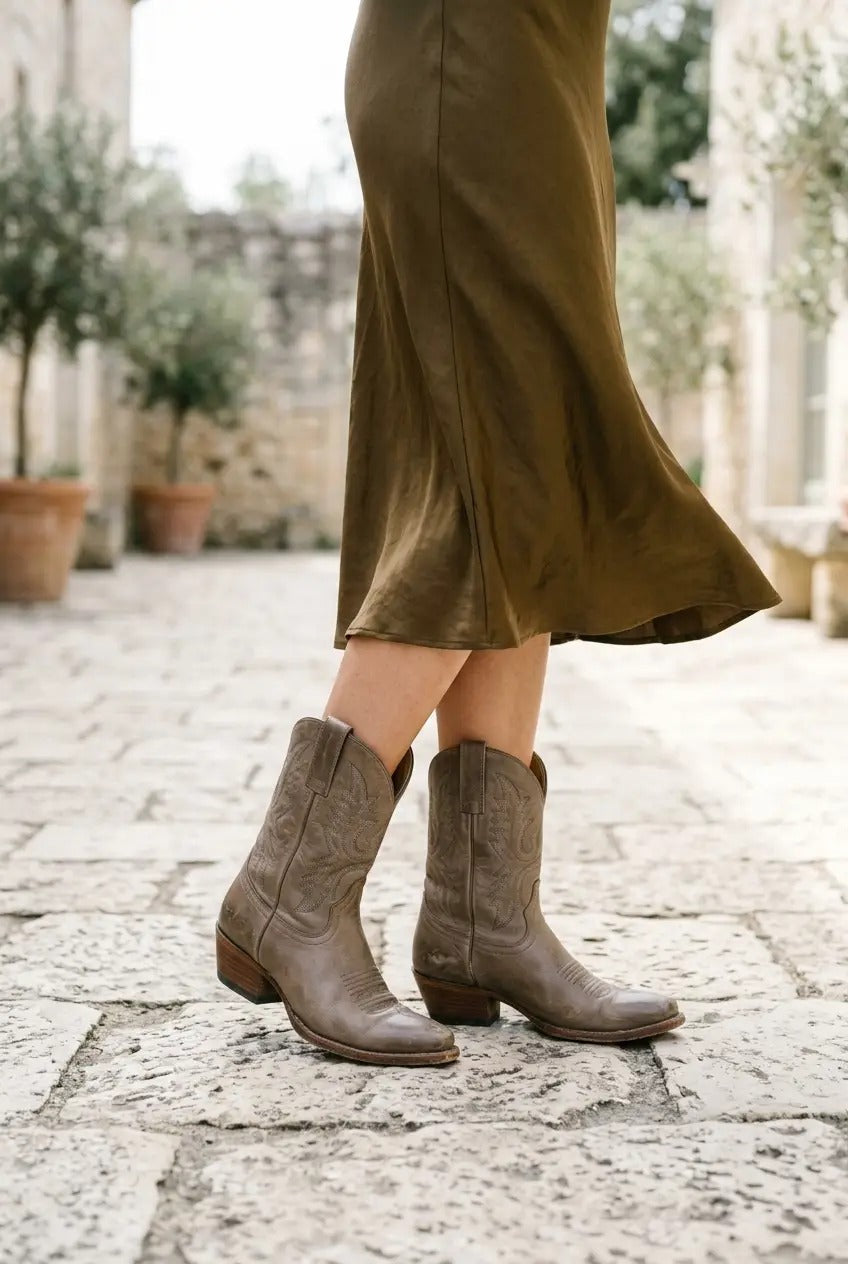 Taupe western boots styled with tailored trousers