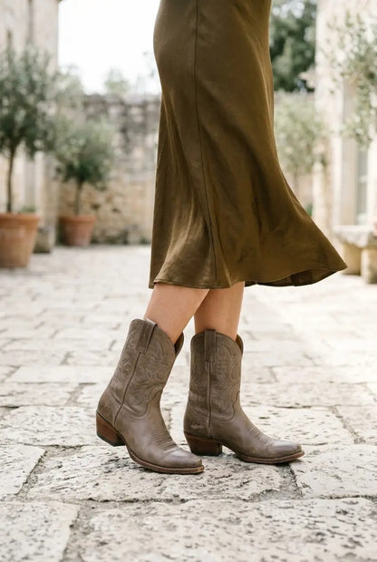 Taupe western boots styled with tailored trousers