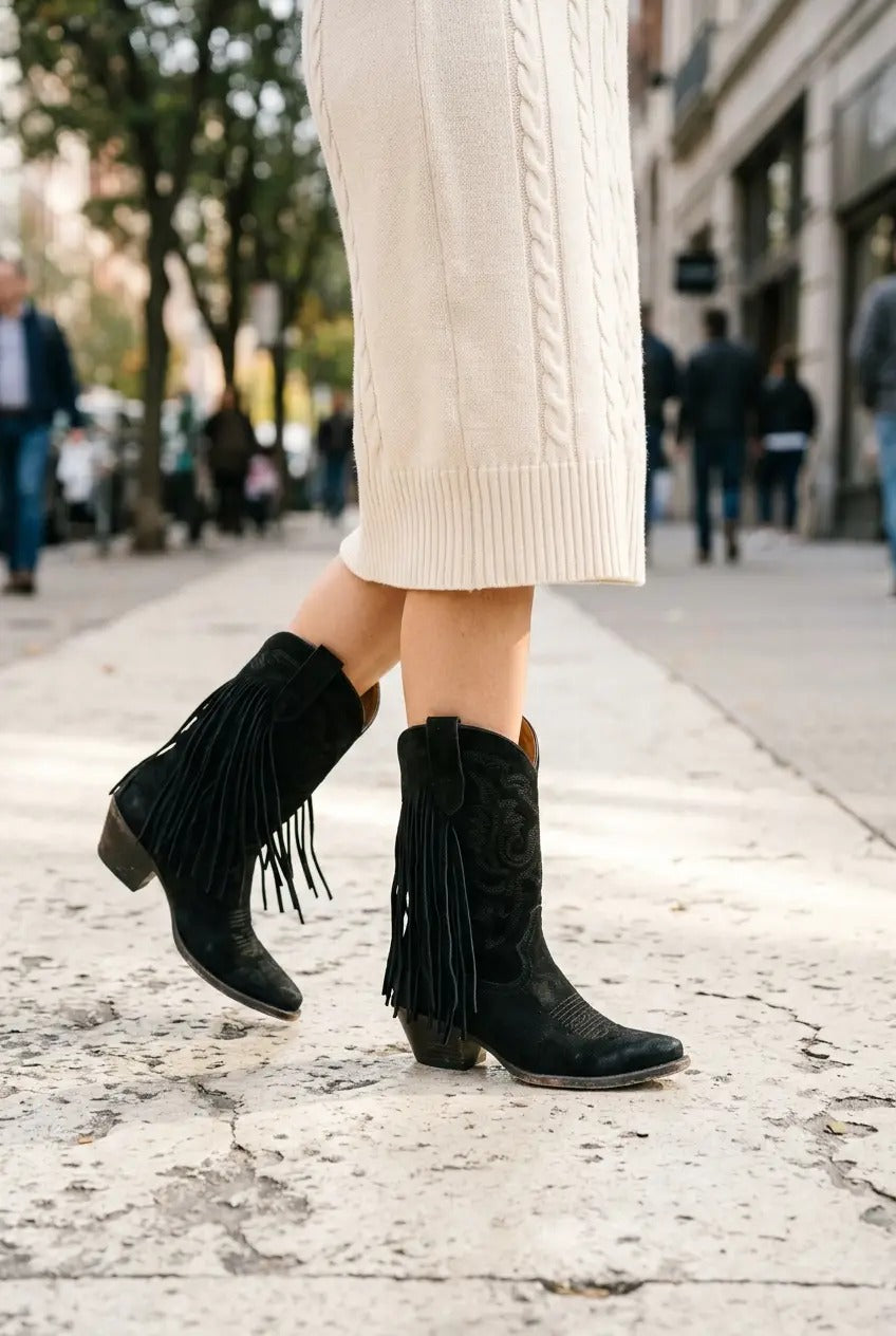 Black fringe boots styled with skinny jeans