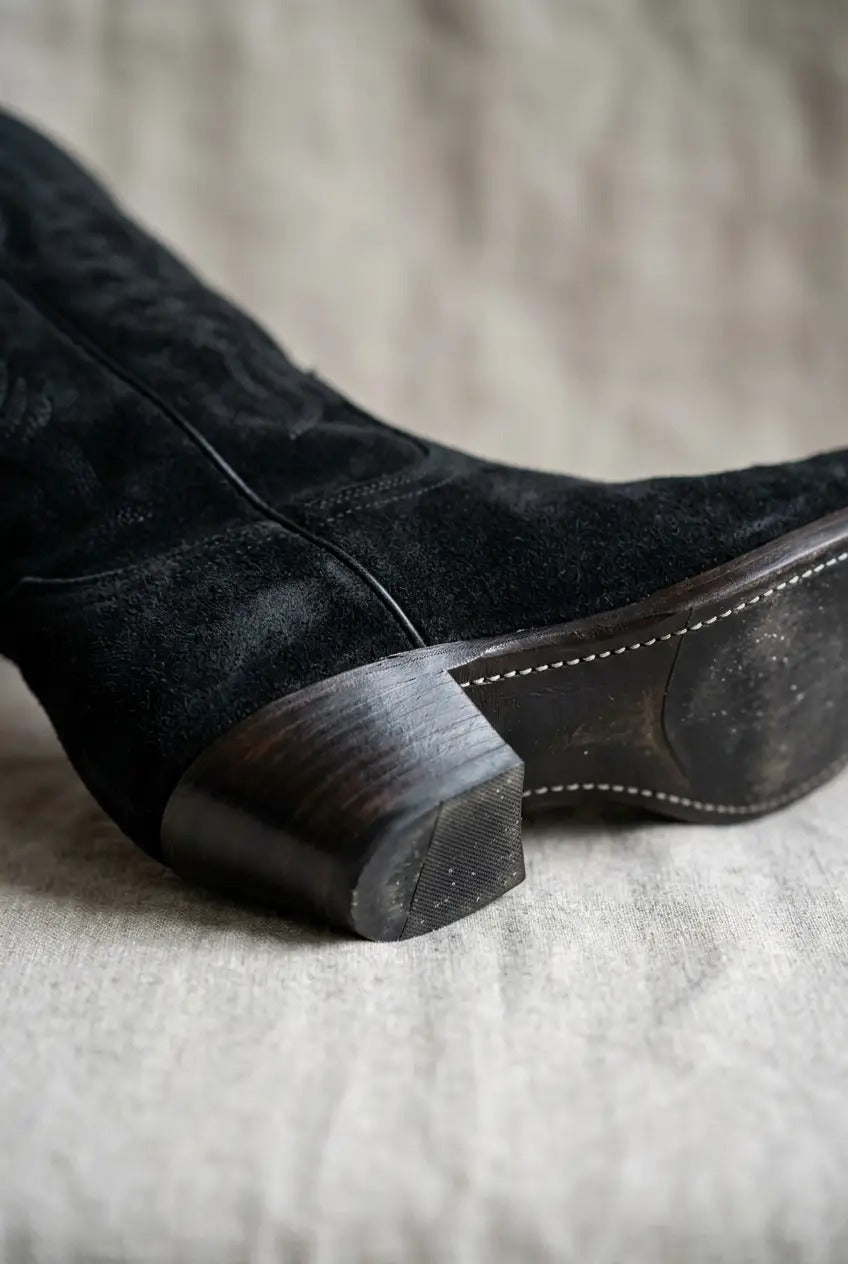 Side view of black wide-calf fringe boots