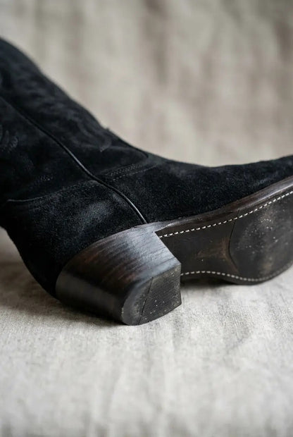 Side view of black wide-calf fringe boots