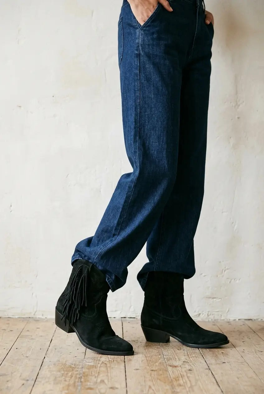 Close-up of fringe detailing on black boot shaft