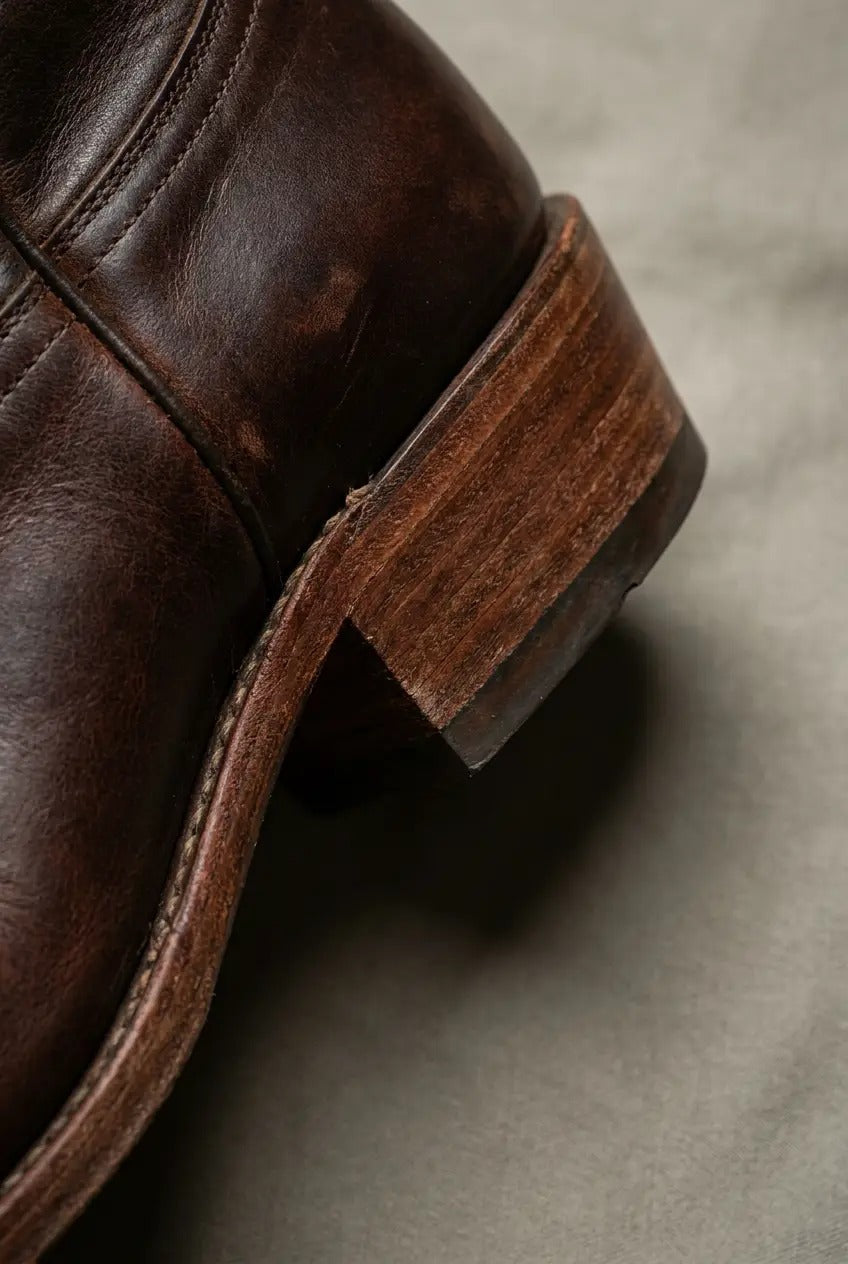 Side view of cognac wide-calf fringe boots
