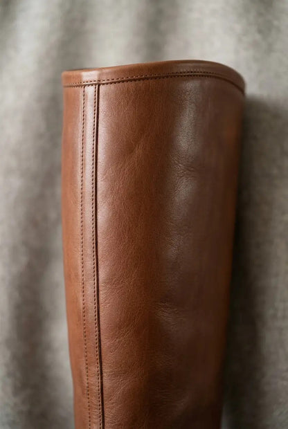 Side view of brown wide-calf knee-high boots showing shaft fit