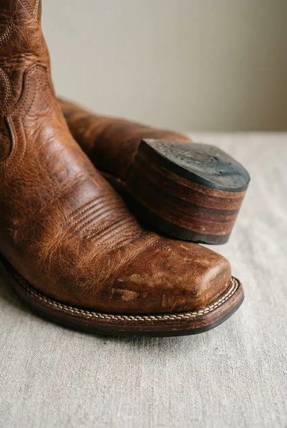 Close-up of square toe and heel on cognac western boot